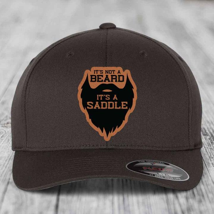 Its Not A Beard, Its A Saddle - Leather Patch Hat - Rawhide to Black Patch - Flexfit 6277 Fitted Hat