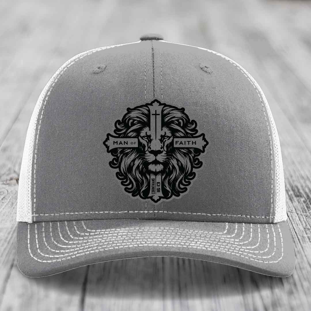 Grey trucker hat with black embroidered lion and cross patch reading &