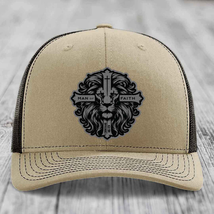 Beige trucker hat with black lion patch reading &