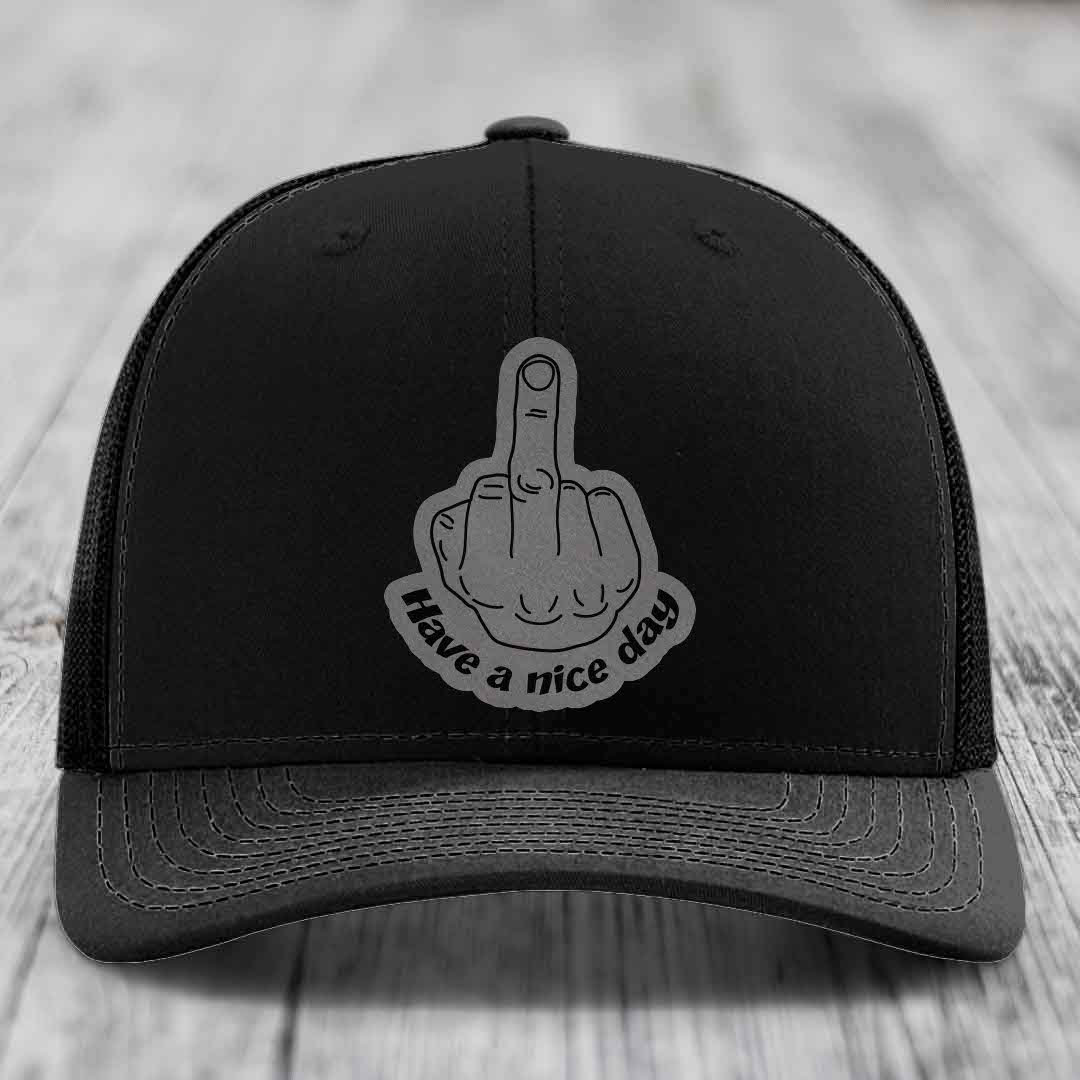 Black trucker hat with grey middle finger patch that says &