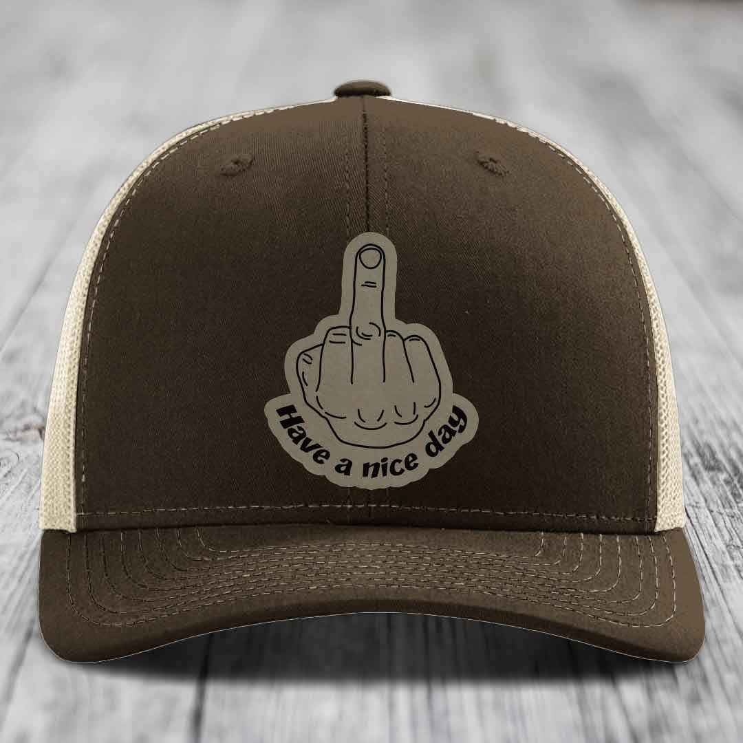 Brown trucker hat with beige mesh back and a gray &