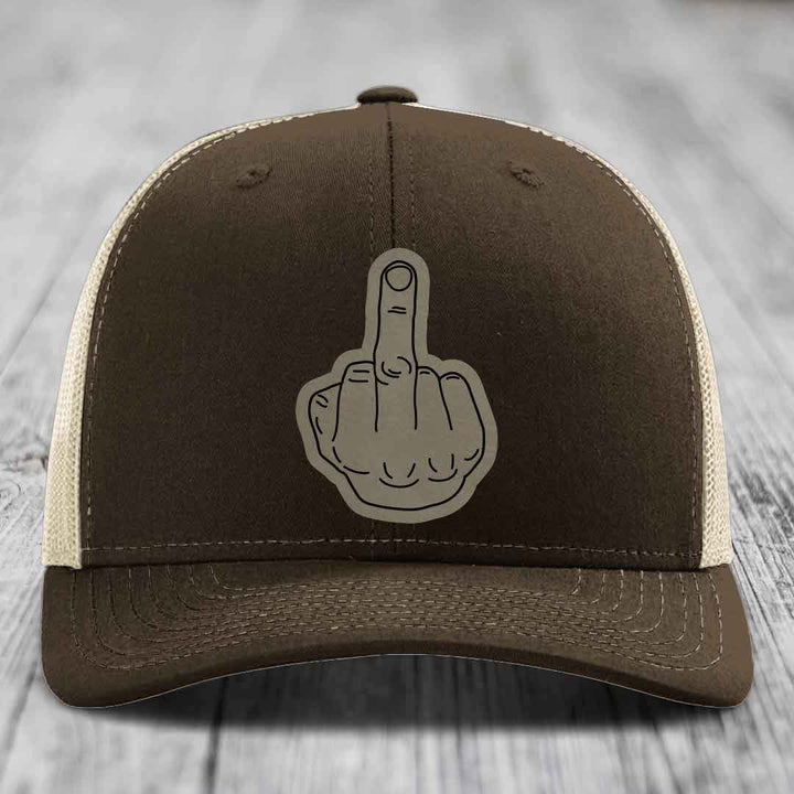 Brown trucker hat with beige mesh back and a grey middle finger patch on front.