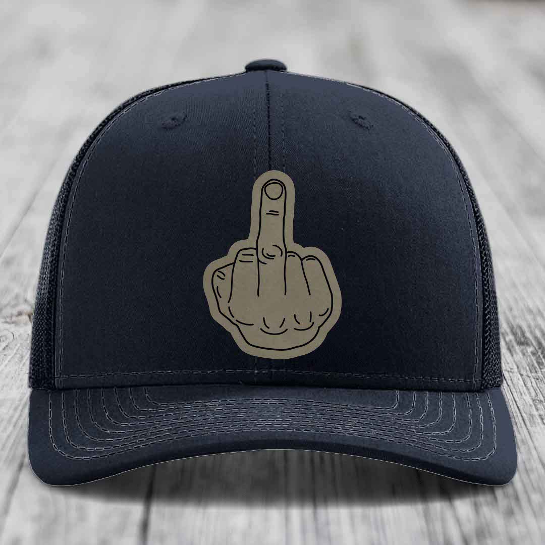 Black trucker hat with a beige middle finger patch on the front.