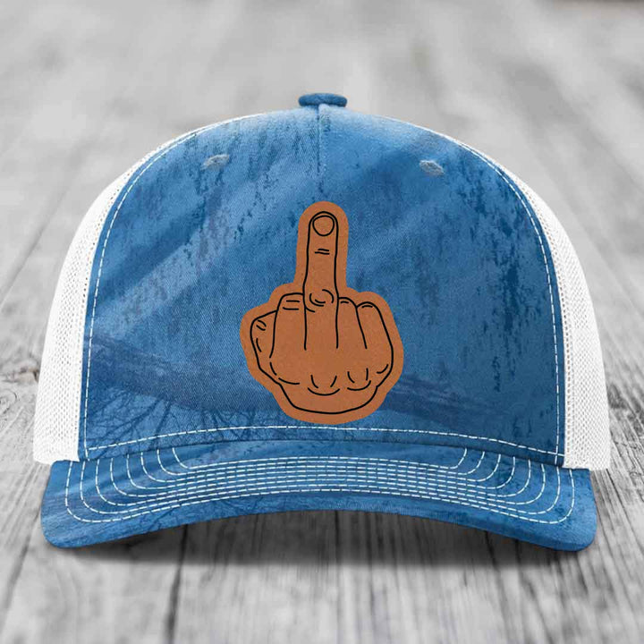 Blue and white trucker hat with a brown leatherette middle finger patch on front.