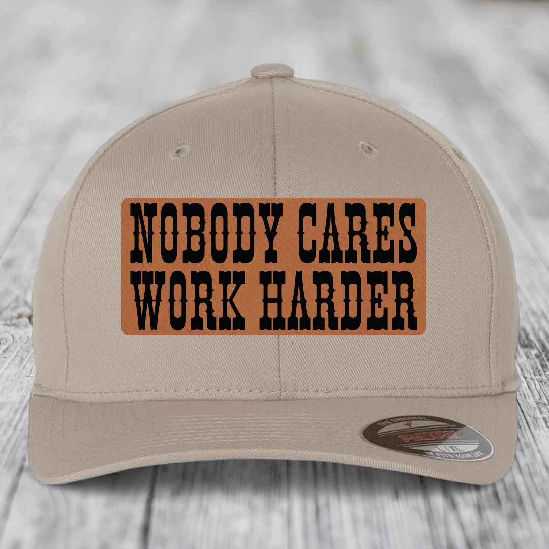 Beige baseball cap with brown leather patch reading &