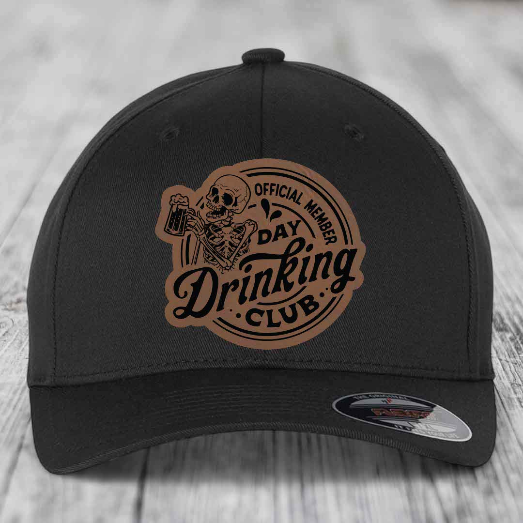 Black baseball cap with brown leather patch featuring skeleton holding beer mug and text &