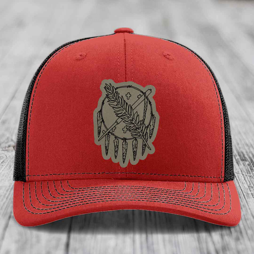 Red trucker hat with black mesh back and gray leather patch featuring a dreamcatcher design.
