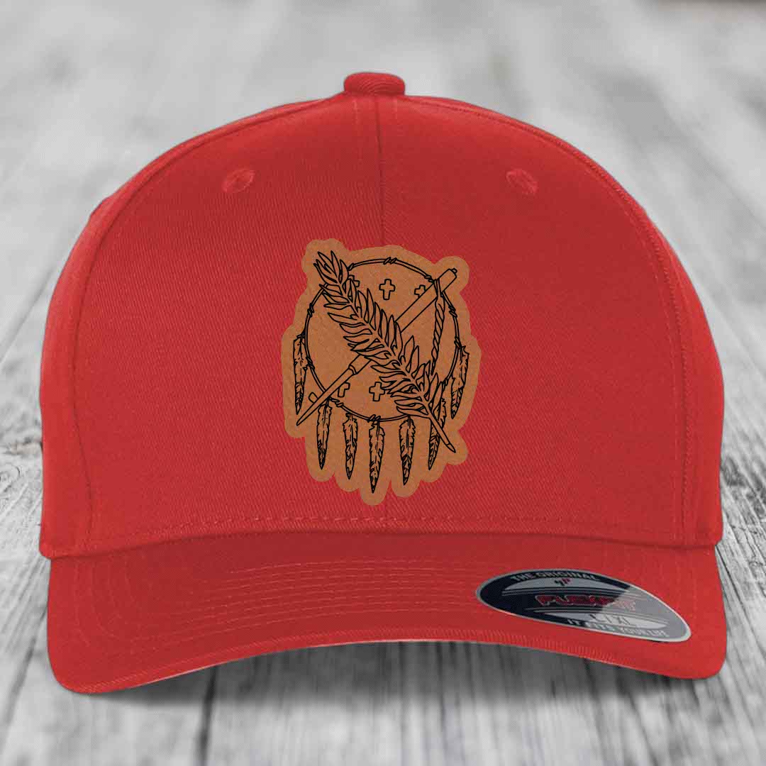 Red baseball cap with brown leather patch featuring a dreamcatcher design.