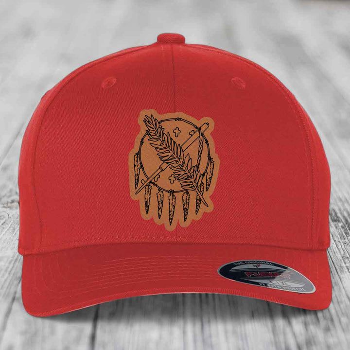 Red baseball cap with brown leather patch featuring a dreamcatcher design.