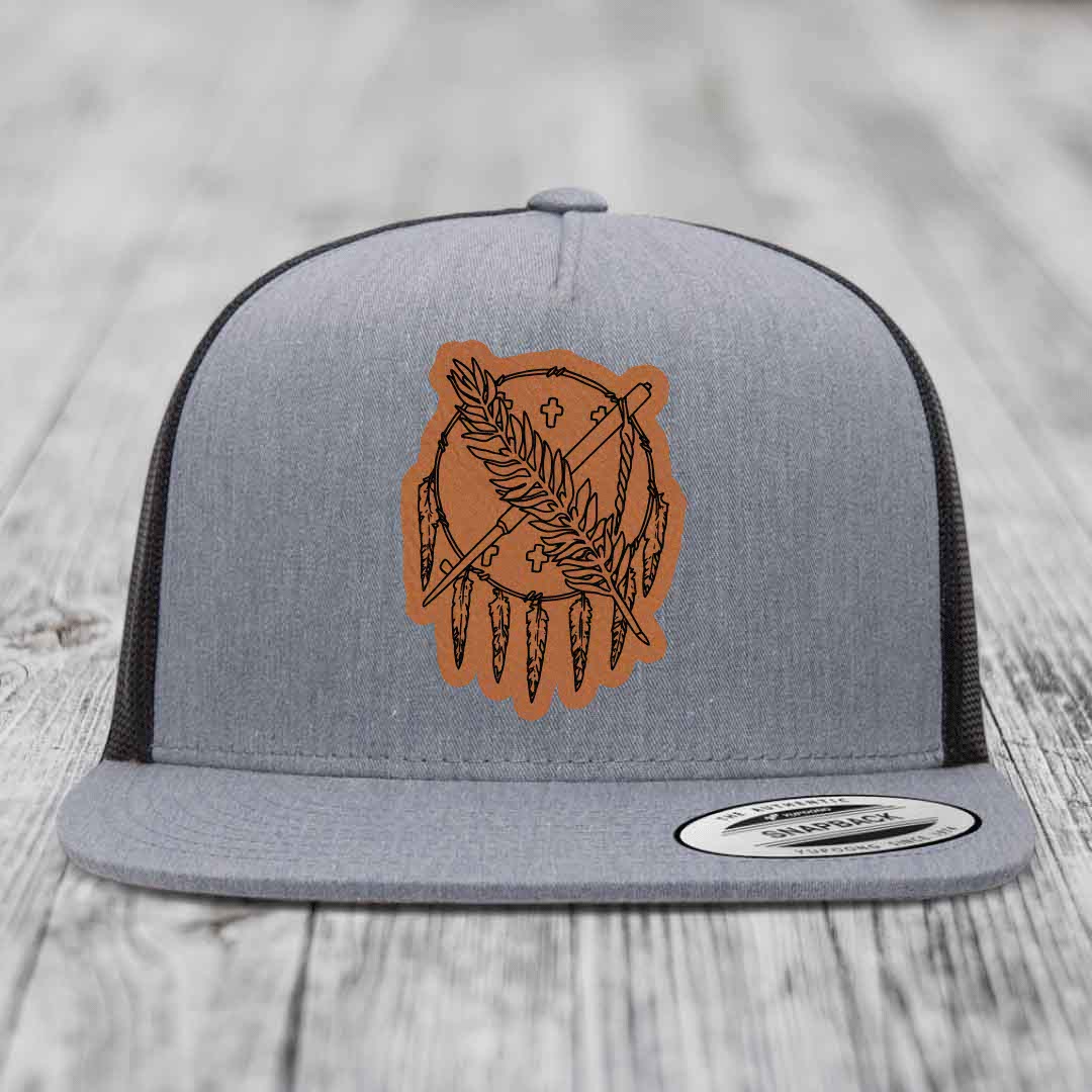 Grey trucker hat with brown leather patch featuring dreamcatcher design.
