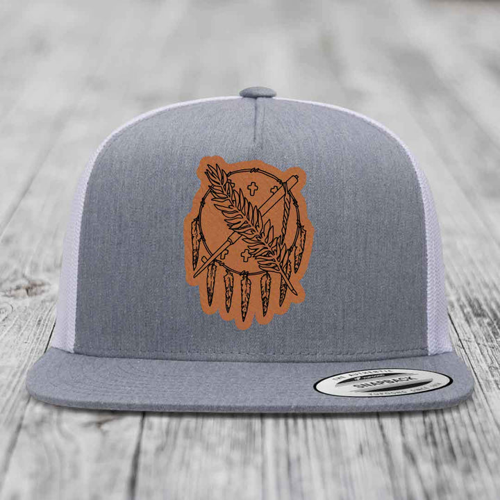 Grey trucker hat with brown leather patch featuring dreamcatcher design.