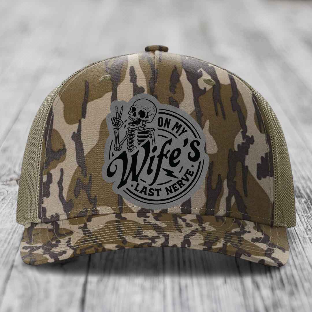 Camouflage trucker hat with a skeleton patch reading &