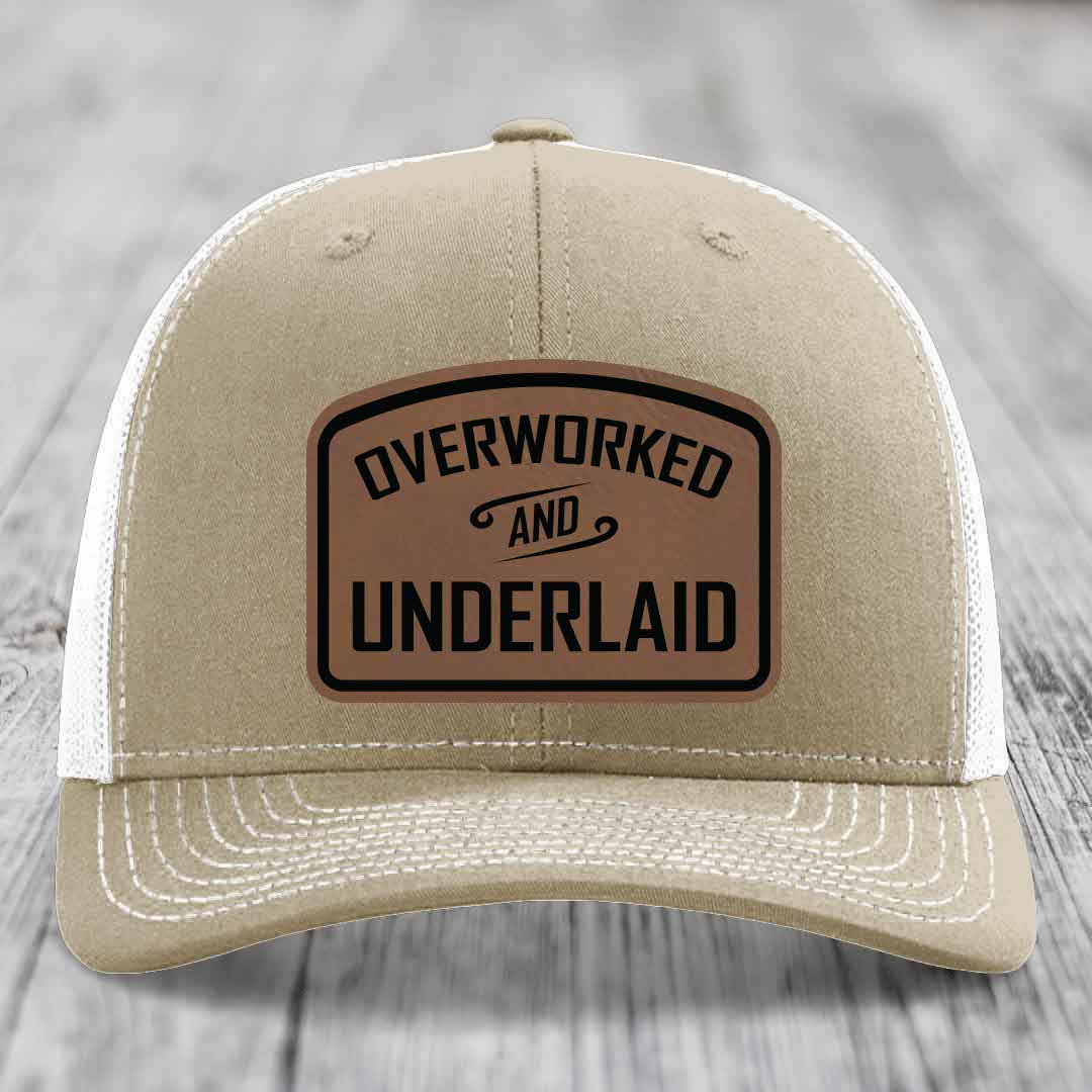 Tan trucker hat with white mesh back and black stitched &
