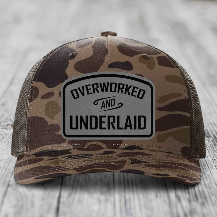Overworked and Underlaid - Leather Patch Hat - Grey to Black Patch - Richardson 112PFP Snapback Trucker Hat