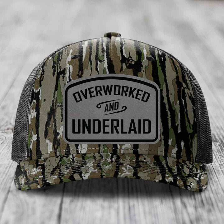Overworked and Underlaid - Leather Patch Hat - Grey to Black Patch - Richardson 112PFP Snapback Trucker Hat