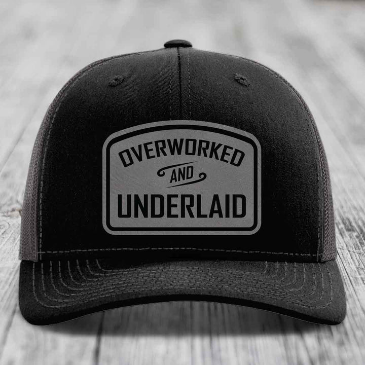 Overworked and Underlaid - Leather Patch Hat - Grey to Black Patch - Richardson 112 Snapback Trucker Hat