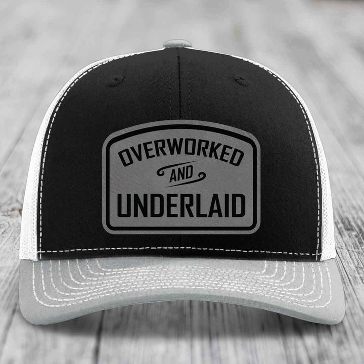 Overworked and Underlaid - Leather Patch Hat - Grey to Black Patch - Richardson 112 Snapback Trucker Hat