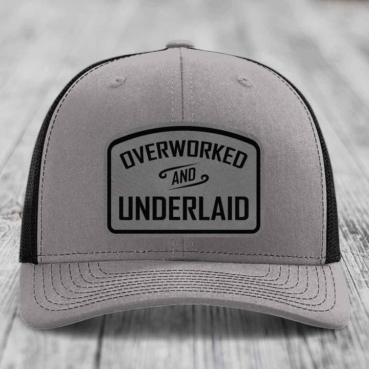 Overworked and Underlaid - Leather Patch Hat - Grey to Black Patch - Richardson 112 Snapback Trucker Hat