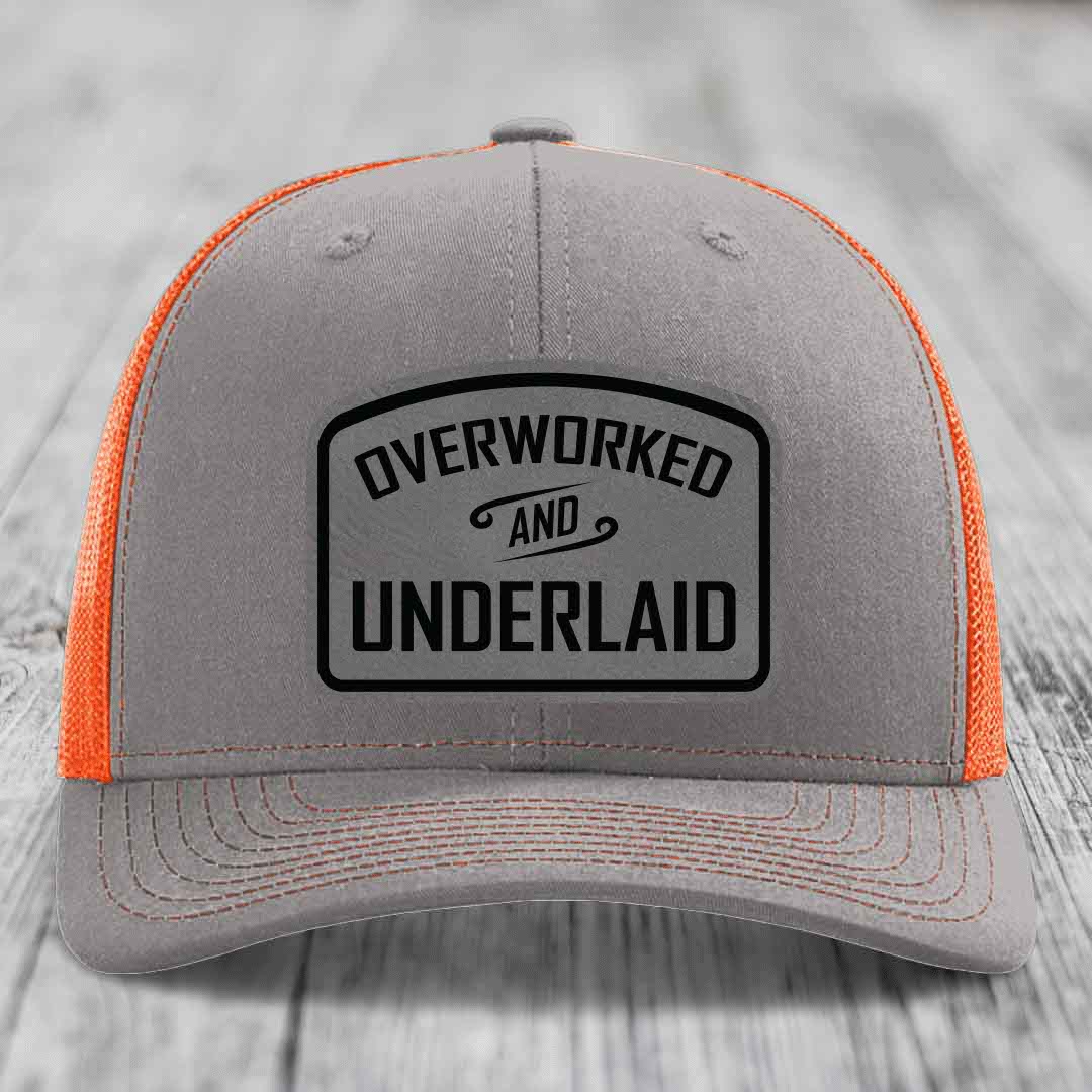 Grey trucker hat with orange mesh back and black &