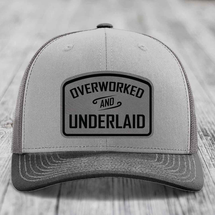 Overworked and Underlaid - Leather Patch Hat - Grey to Black Patch - Richardson 112 Snapback Trucker Hat
