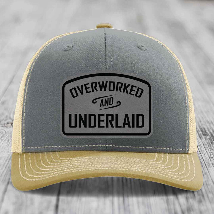 Overworked and Underlaid - Leather Patch Hat - Grey to Black Patch - Richardson 112 Snapback Trucker Hat