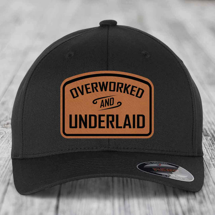 Overworked and Underlaid - Leather Patch Hat - Rawhide to Black Patch - Flexfit 6277 Fitted Hat