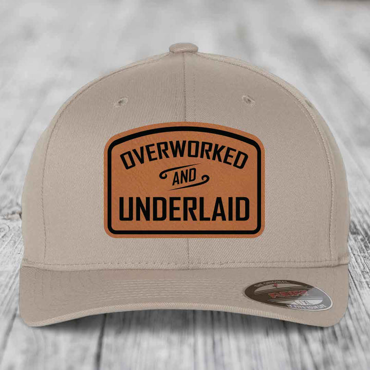 Overworked and Underlaid - Leather Patch Hat - Rawhide to Black Patch - Flexfit 6277 Fitted Hat