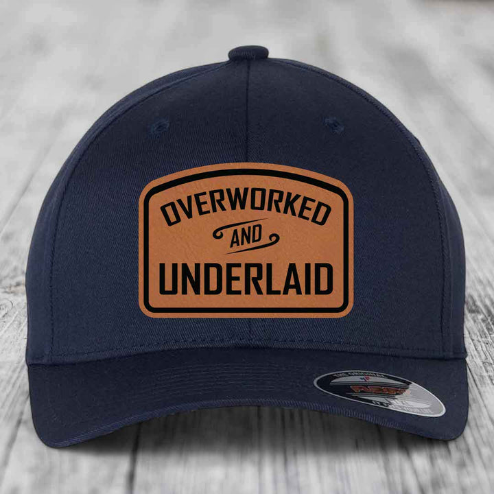 Overworked and Underlaid - Leather Patch Hat - Rawhide to Black Patch - Flexfit 6277 Fitted Hat