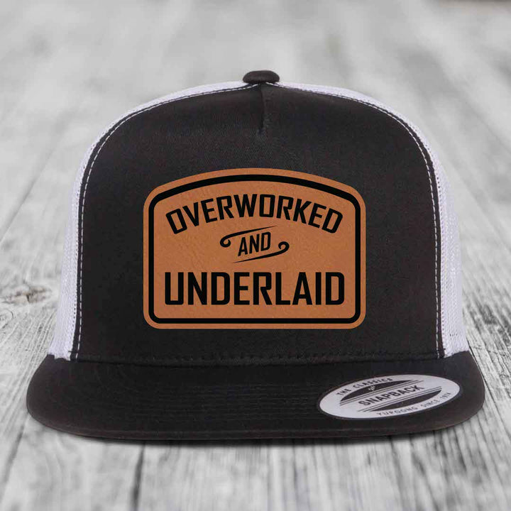 Overworked and Underlaid - Leather Patch Hat - Rawhide to Black Patch - Yupoong 6006 Snapback Flatbill Hat