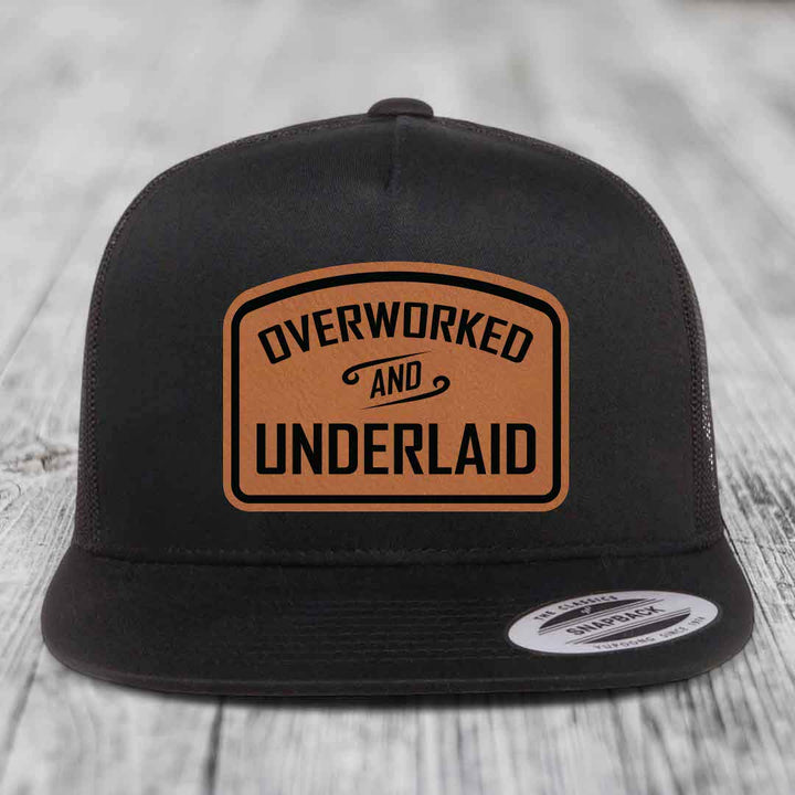 Overworked and Underlaid - Leather Patch Hat - Rawhide to Black Patch - Yupoong 6006 Snapback Flatbill Hat