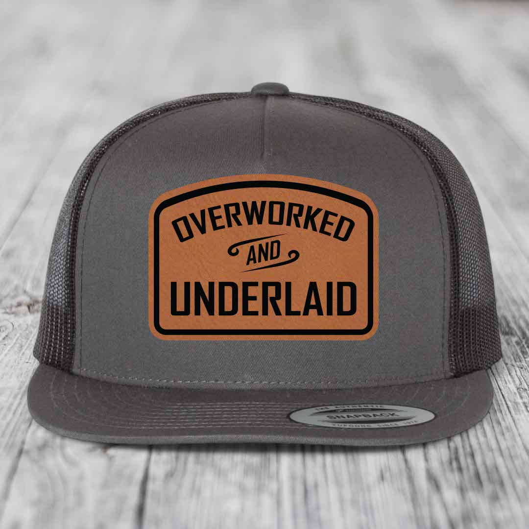 Overworked and Underlaid - Leather Patch Hat - Rawhide to Black Patch - Yupoong 6006 Snapback Flatbill Hat