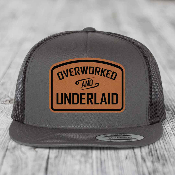 Overworked and Underlaid - Leather Patch Hat - Rawhide to Black Patch - Yupoong 6006 Snapback Flatbill Hat