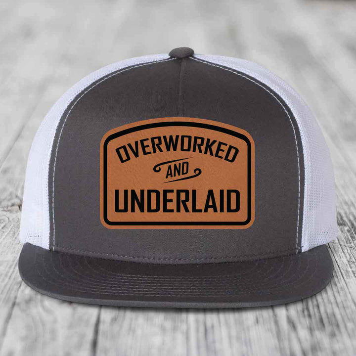 Overworked and Underlaid - Leather Patch Hat - Rawhide to Black Patch - Yupoong 6006 Snapback Flatbill Hat