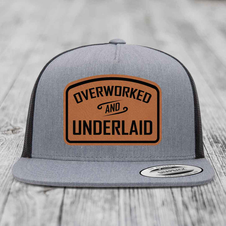Overworked and Underlaid - Leather Patch Hat - Rawhide to Black Patch - Yupoong 6006 Snapback Flatbill Hat