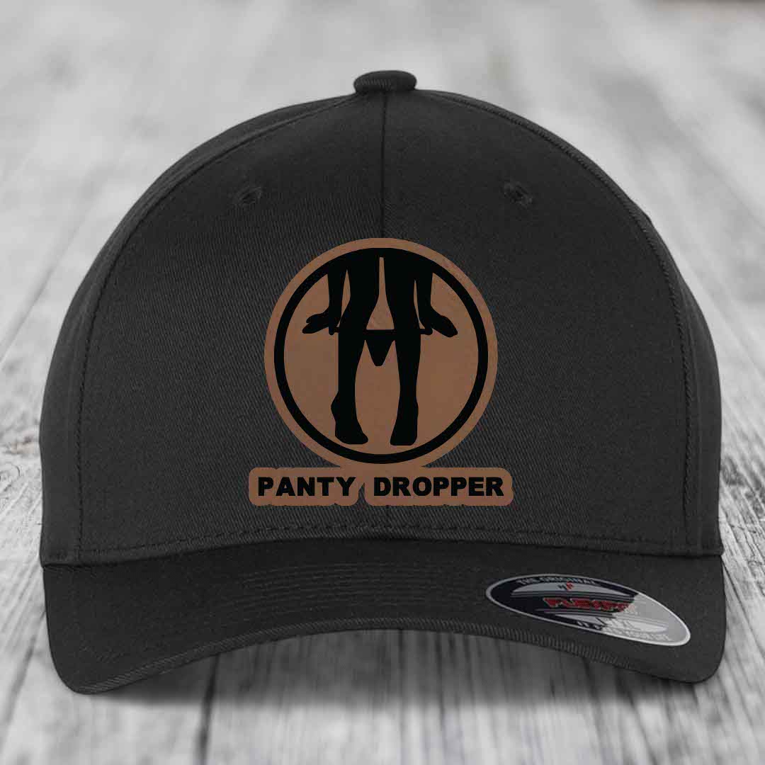 Black baseball cap with brown circular patch featuring black silhouette of legs and text &