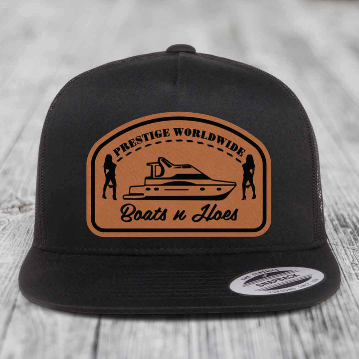 Prestige Worldwide, Boats and Hoes - Leather Patch Hat - Rawhide to Black Patch - Yupoong 6006 Snapback Flatbill Hat
