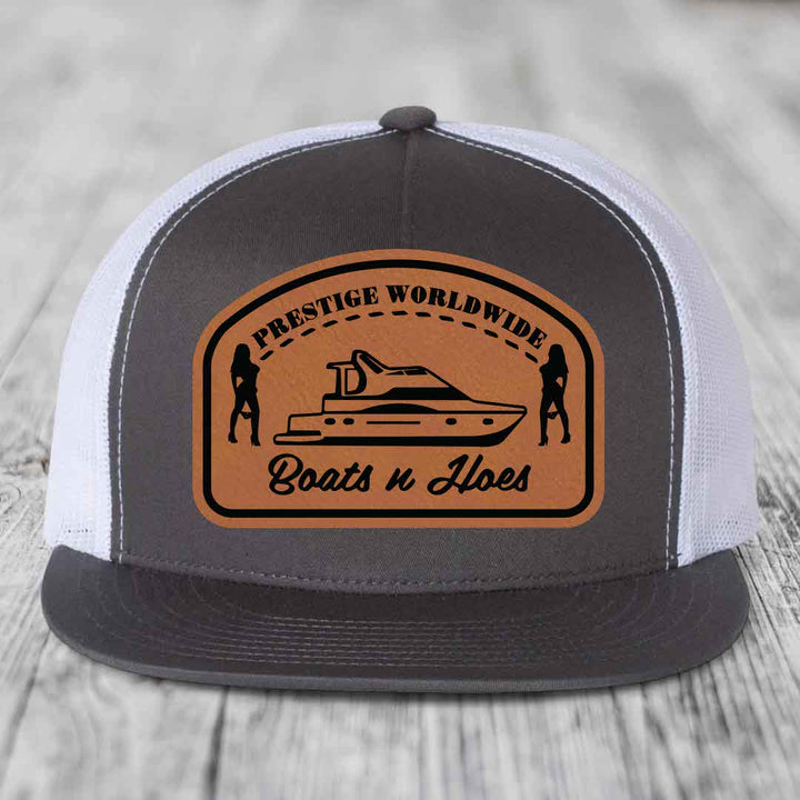 Prestige Worldwide, Boats and Hoes - Leather Patch Hat - Rawhide to Black Patch - Yupoong 6006 Snapback Flatbill Hat