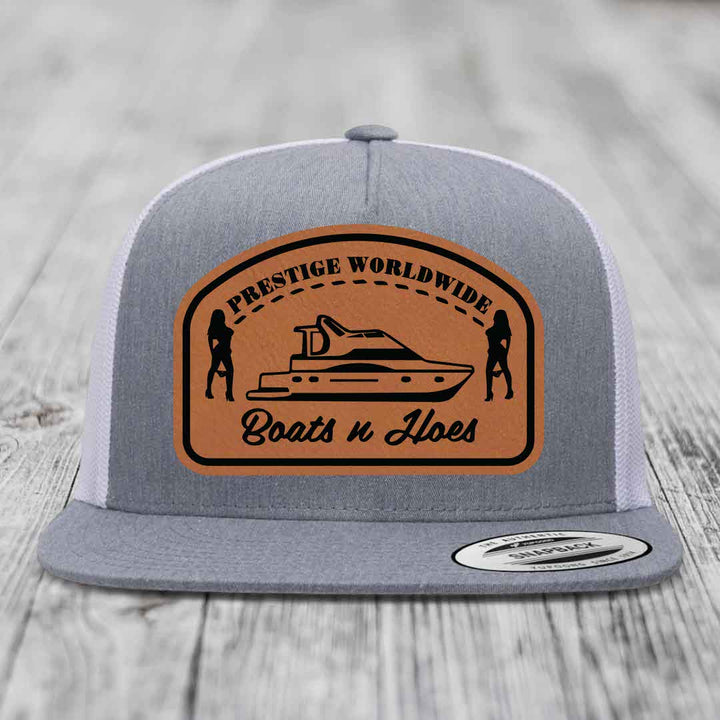 Prestige Worldwide, Boats and Hoes - Leather Patch Hat - Rawhide to Black Patch - Yupoong 6006 Snapback Flatbill Hat