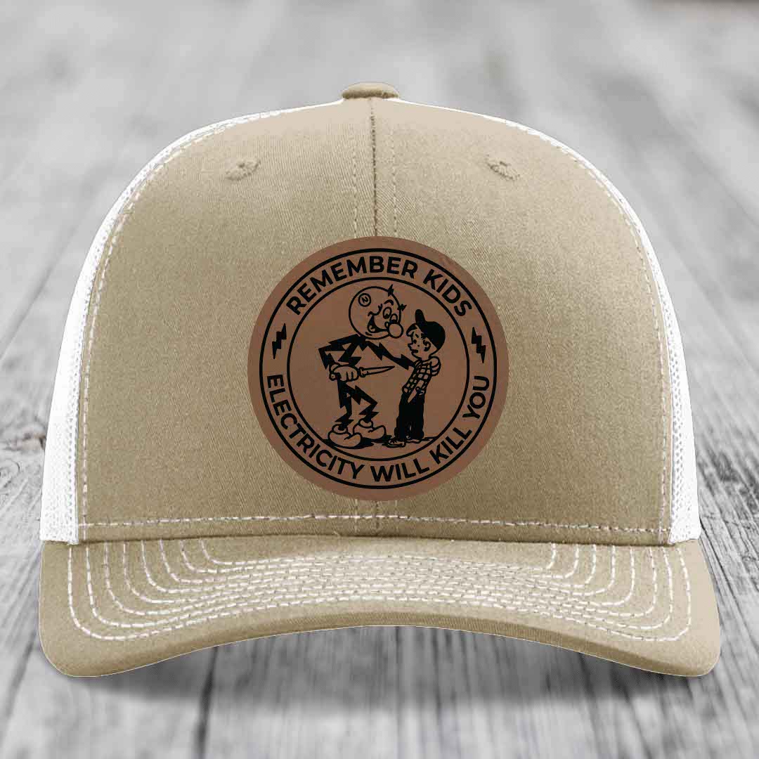 Tan trucker hat with brown circular leather patch reading &