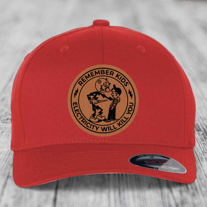 Red baseball cap with circular brown patch showing cartoon character and text &
