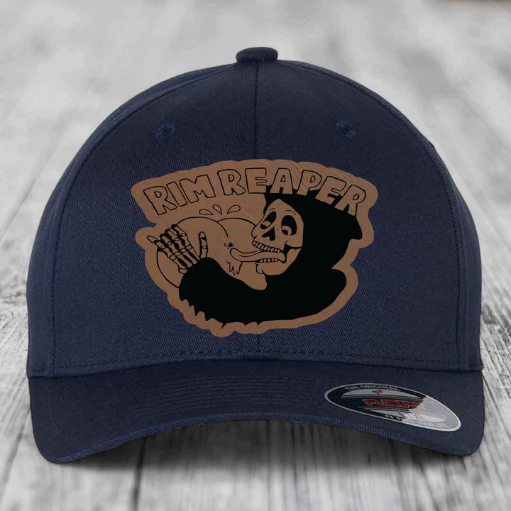 Dark blue baseball cap with a tan leatherette patch featuring a skeleton holding a basketball and the text &