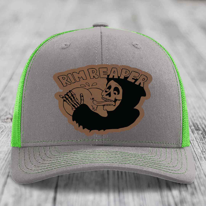 Grey trucker hat with neon green mesh and stitching, featuring a brown &