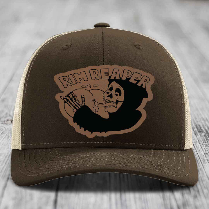 Brown trucker hat with beige mesh back and embroidered &