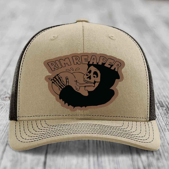Beige trucker hat with black mesh back and embroidered &