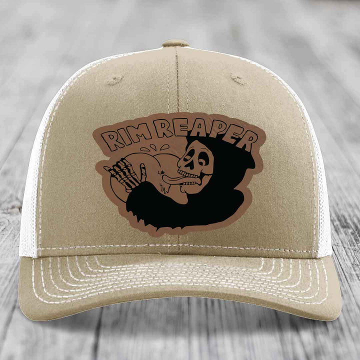 Tan trucker hat with embroidered &