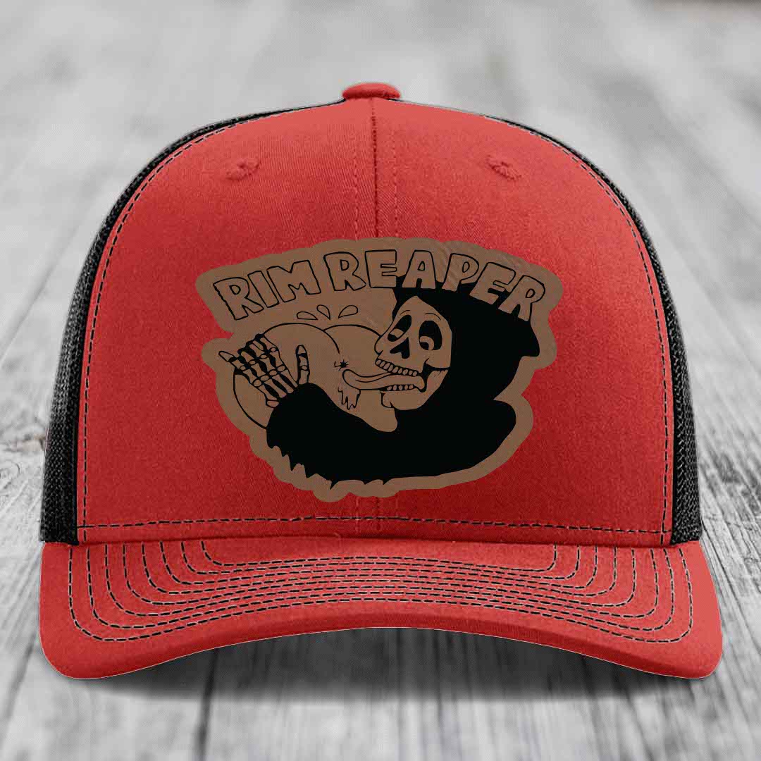 Red trucker hat with black mesh back and embroidered &