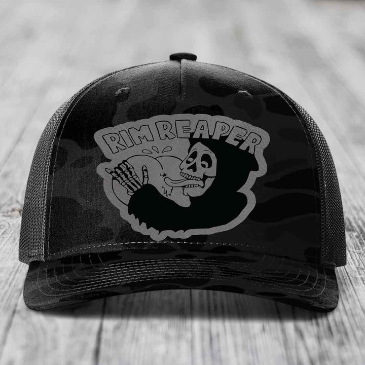 Black trucker hat with grey camo pattern and &
