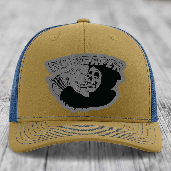 Tan and blue trucker hat with &