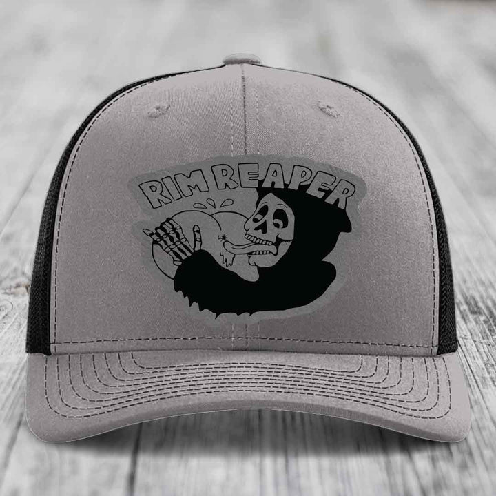 Grey trucker hat with black mesh back and embroidered &