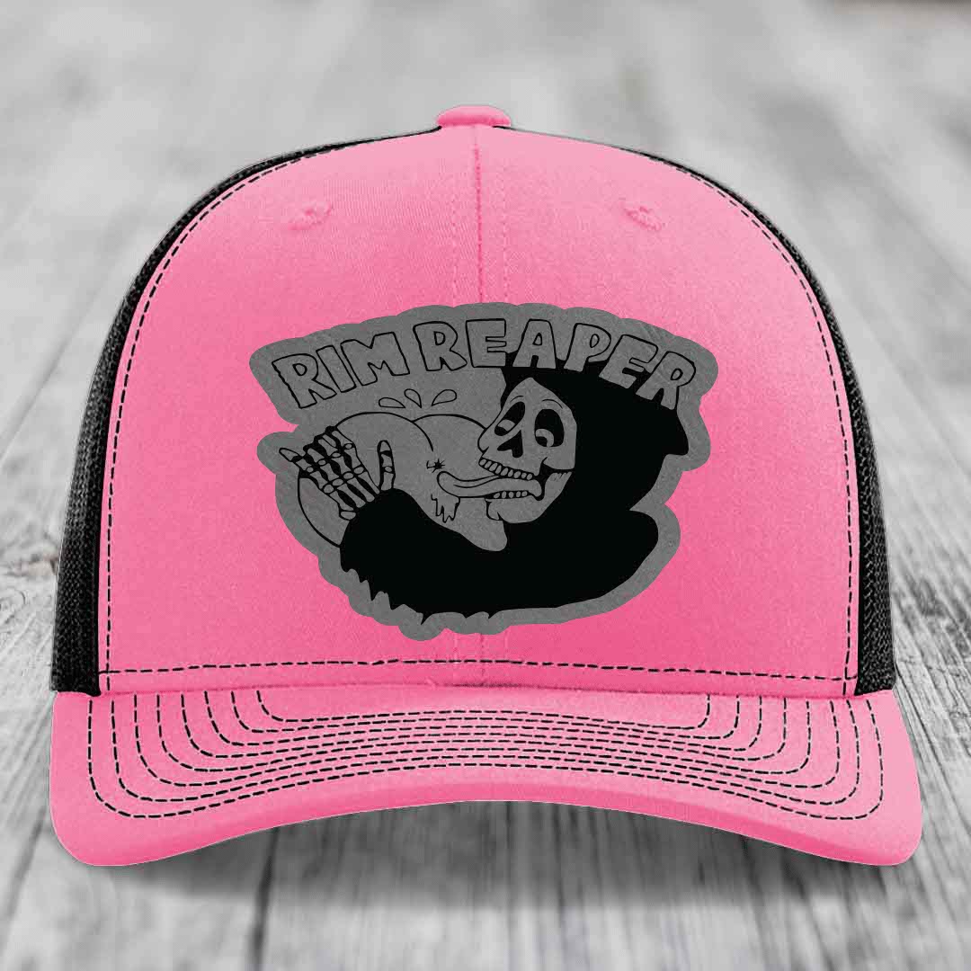 Pink trucker hat with black mesh back and gray skull graphic that says Rim Reaper